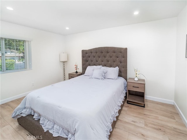 bedroom with light wood finished floors, recessed lighting, and baseboards