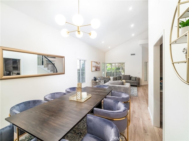 dining area featuring a notable chandelier, recessed lighting, visible vents, stairway, and light wood-style flooring