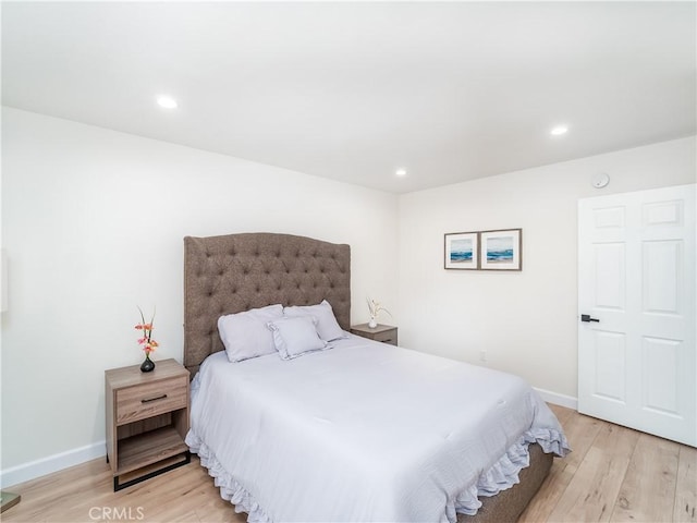 bedroom with light wood-type flooring, baseboards, and recessed lighting