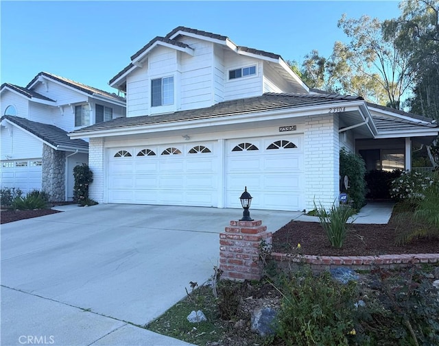 view of side of home with concrete driveway and brick siding