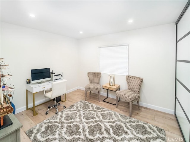 home office featuring baseboards, wood finished floors, and recessed lighting