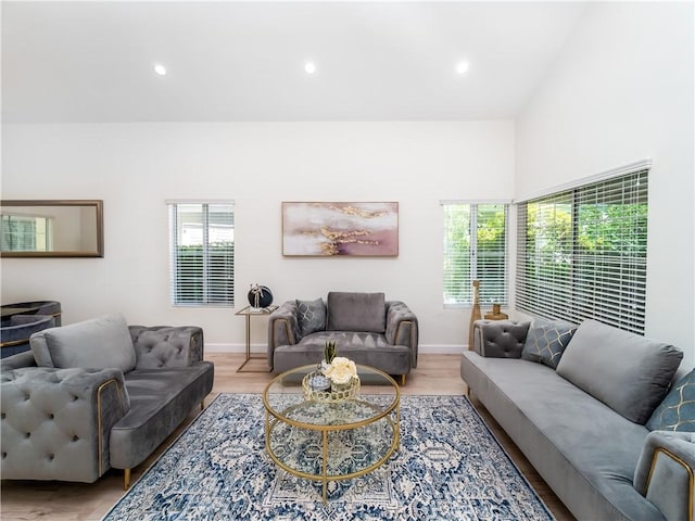 living area with light wood-style floors, recessed lighting, and baseboards