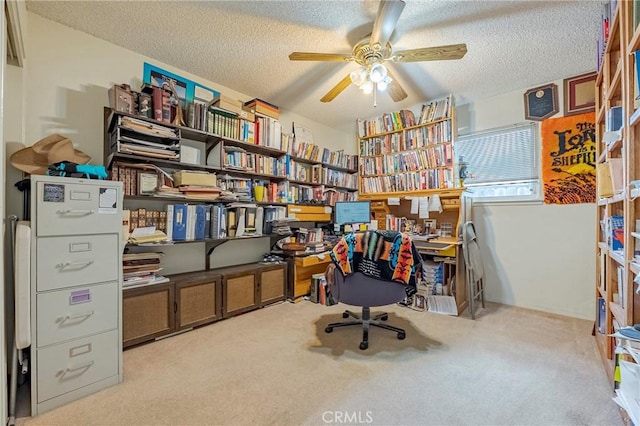 office space featuring carpet floors, ceiling fan, and a textured ceiling