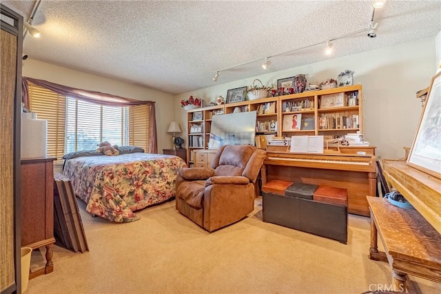 bedroom with a textured ceiling and light colored carpet