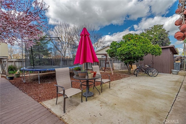 view of patio / terrace with a trampoline and a fenced backyard