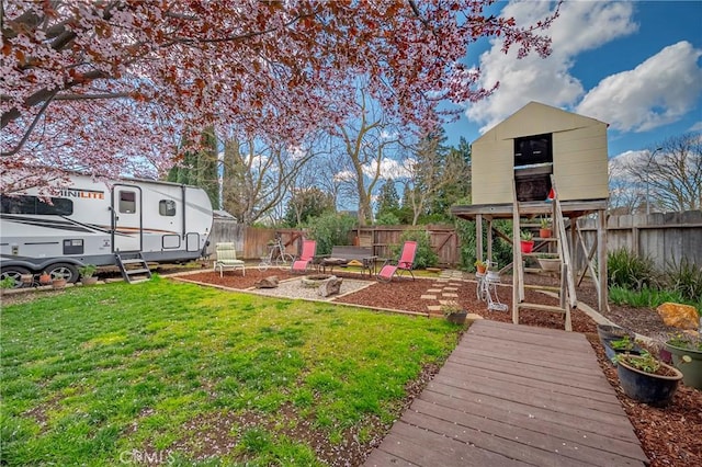 view of yard with an outdoor fire pit and a fenced backyard