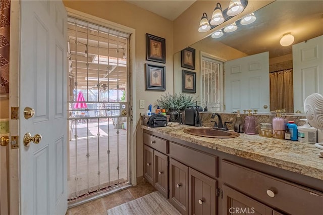 bathroom featuring tile patterned flooring and vanity