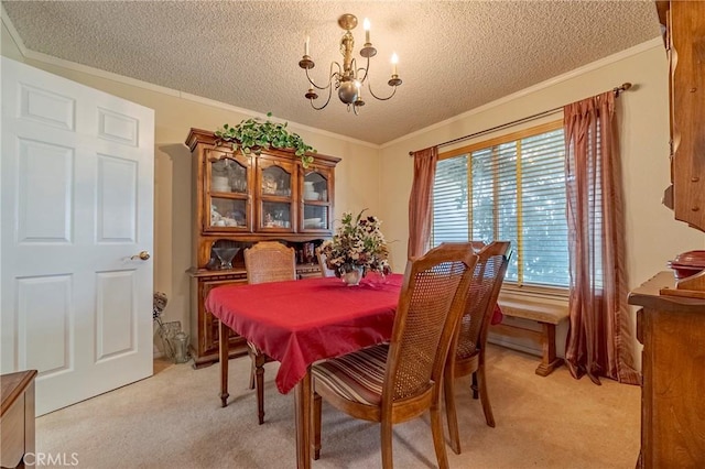 dining area featuring a textured ceiling, ornamental molding, light colored carpet, and a notable chandelier