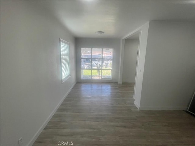 interior space with wood finished floors and baseboards