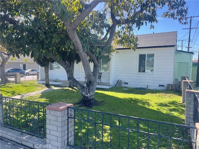 view of front of house featuring a fenced front yard, roof with shingles, covered porch, crawl space, and a front lawn