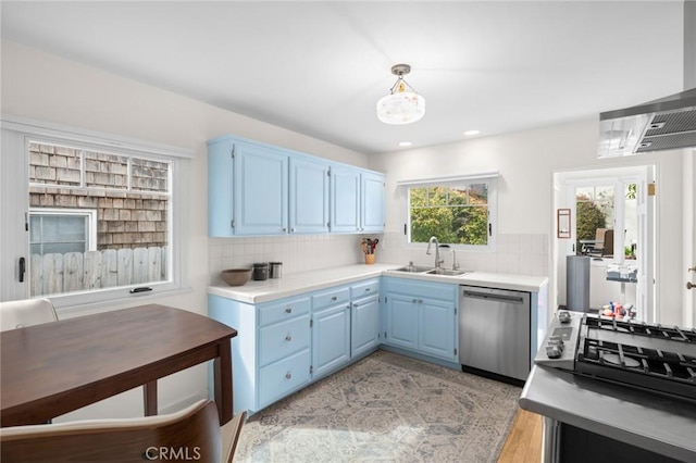 kitchen featuring a sink, blue cabinets, tasteful backsplash, and dishwasher