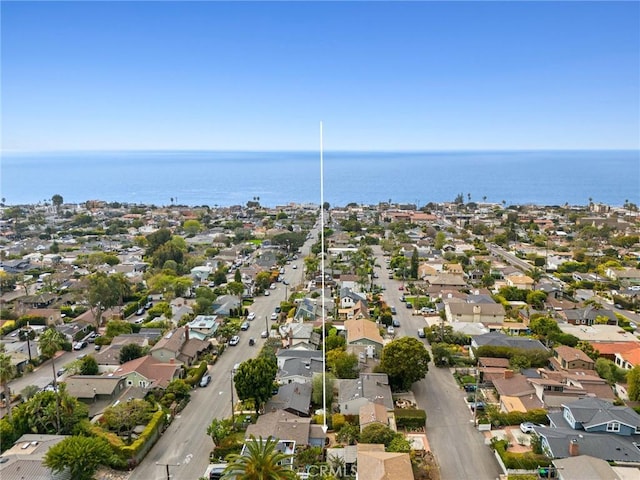 drone / aerial view featuring a water view and a residential view