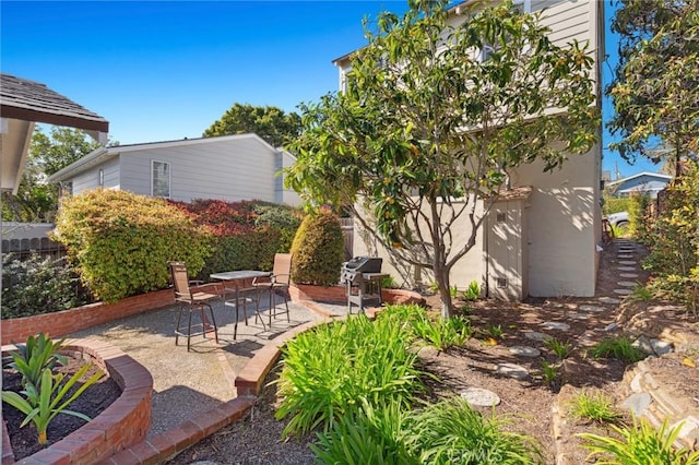 view of patio / terrace with a grill and fence