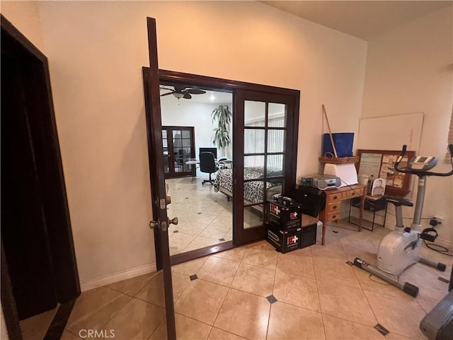 entryway with french doors, baseboards, and light tile patterned floors