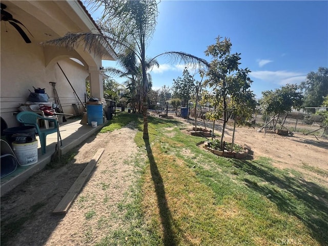 view of yard with a ceiling fan and a fenced backyard