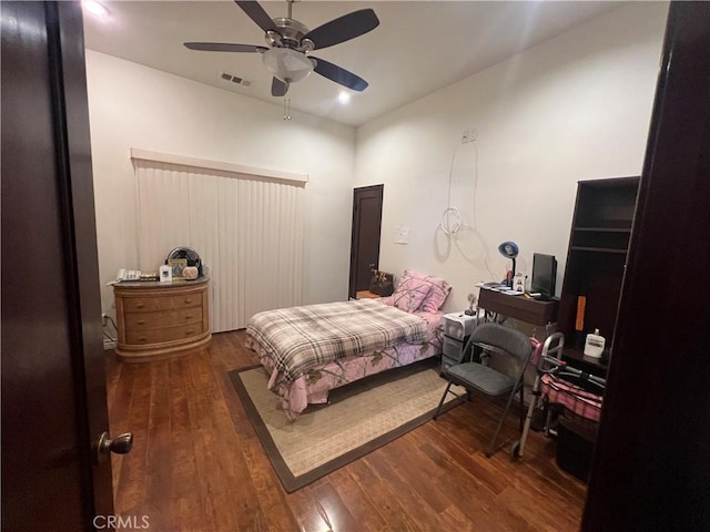 bedroom featuring ceiling fan, visible vents, and wood finished floors