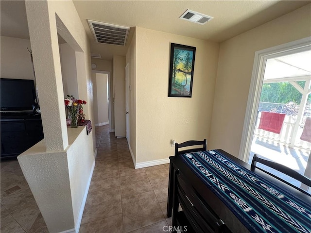 tiled bedroom featuring baseboards and visible vents