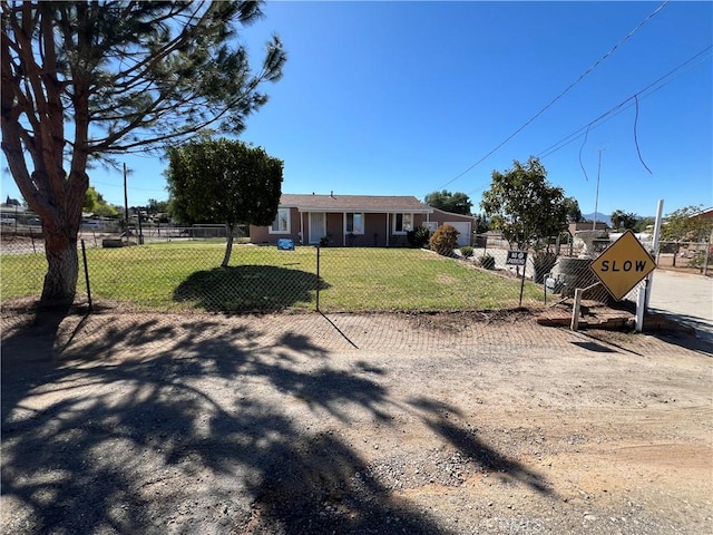 view of front facade with a fenced front yard and a front lawn