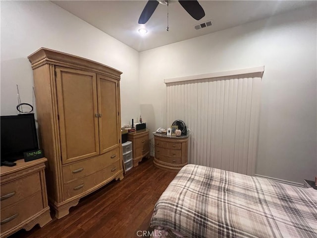 bedroom with ceiling fan, dark wood finished floors, and visible vents