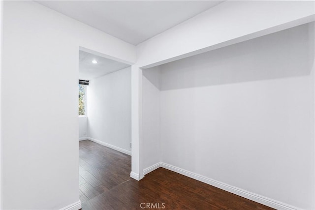 empty room featuring dark wood-style floors, recessed lighting, and baseboards