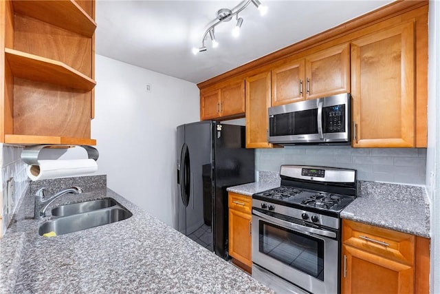 kitchen with appliances with stainless steel finishes, a sink, backsplash, and open shelves