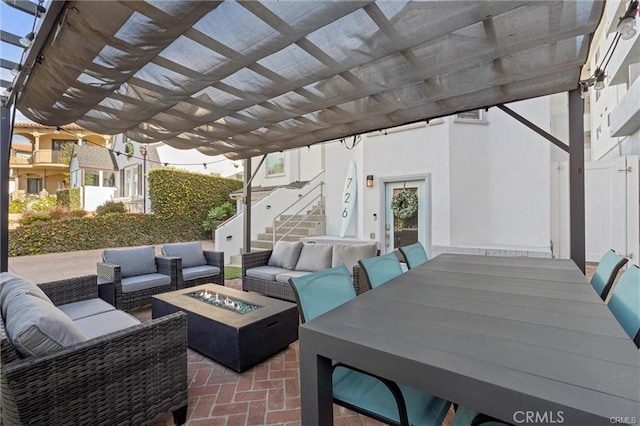 view of patio / terrace with outdoor dining area and an outdoor living space with a fire pit