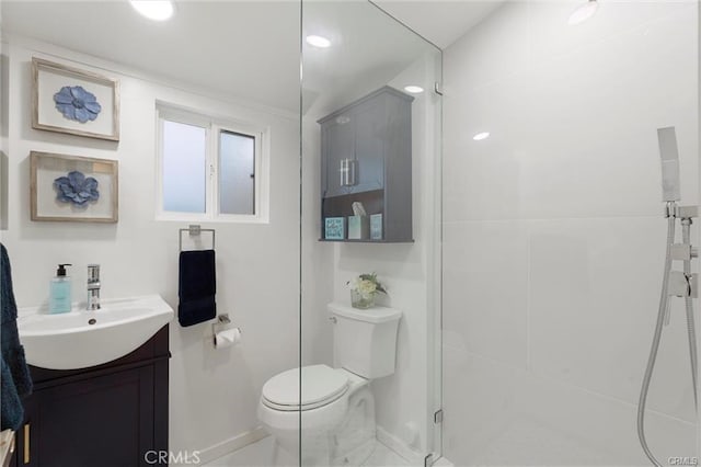 bathroom featuring toilet, a shower stall, baseboards, and vanity