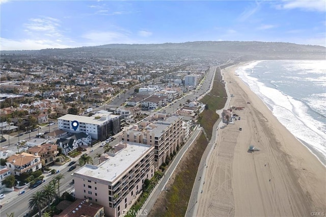 bird's eye view featuring a water view and a beach view