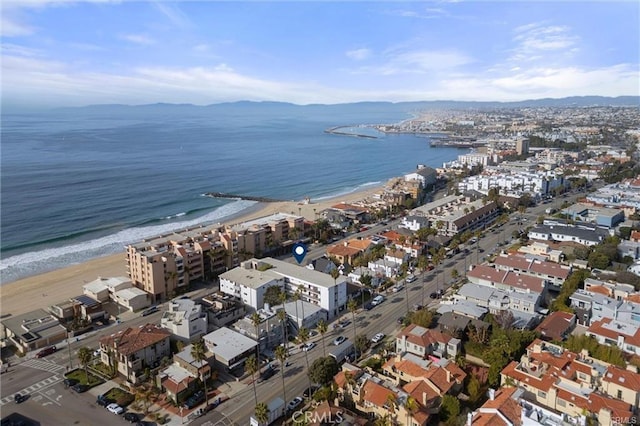 bird's eye view with a water view and a beach view