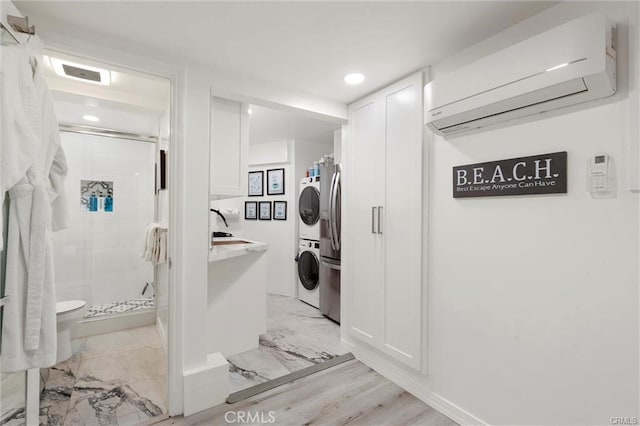 washroom featuring marble finish floor, a wall unit AC, stacked washer / drying machine, recessed lighting, and laundry area