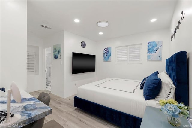 bedroom with wood finished floors, visible vents, and recessed lighting