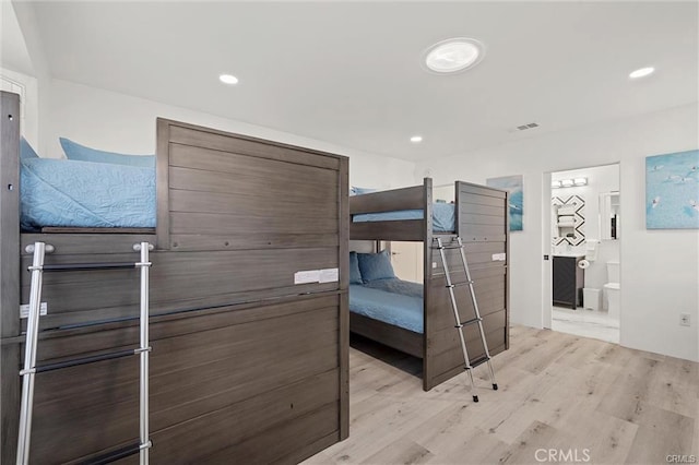 bedroom with light wood-type flooring, visible vents, and recessed lighting