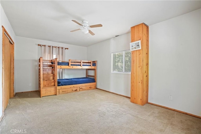 unfurnished bedroom featuring carpet, ceiling fan, and baseboards