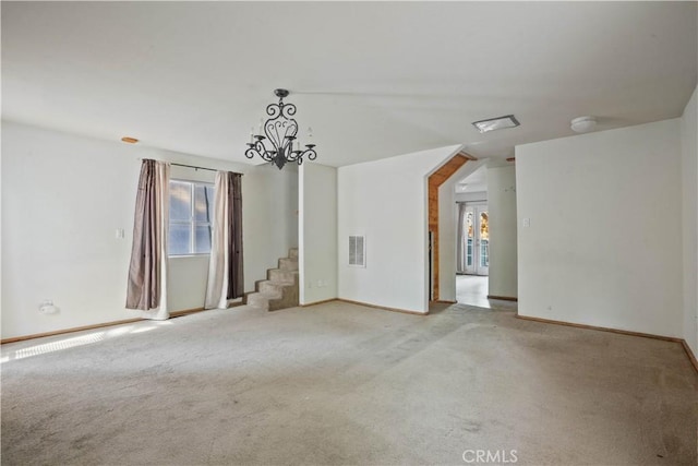 empty room with stairs, light colored carpet, visible vents, and an inviting chandelier