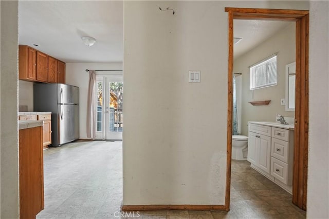 hallway with a sink and light floors