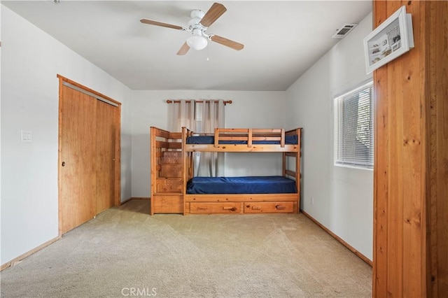 bedroom with carpet floors, a closet, ceiling fan, and baseboards