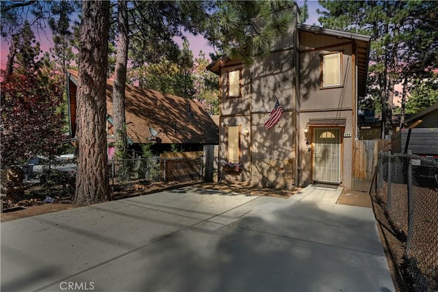 rustic home featuring a patio area and fence