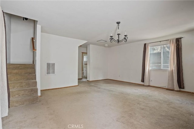 unfurnished room featuring light colored carpet, visible vents, an inviting chandelier, and stairs