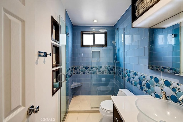 bathroom featuring vanity, tile patterned flooring, a shower stall, and toilet