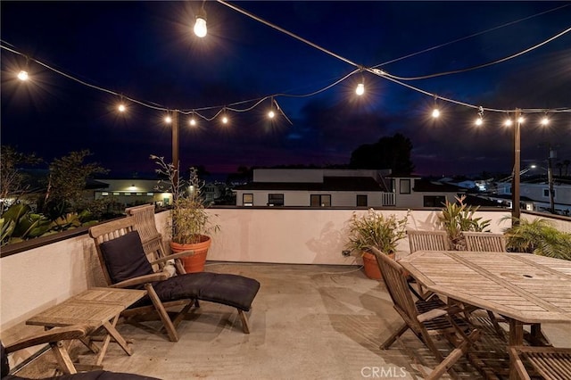 patio at night featuring outdoor dining space