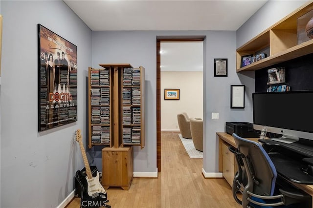 office with light wood-type flooring and baseboards