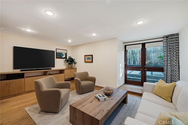 living room with light wood-style floors, recessed lighting, and french doors