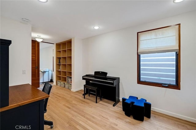 home office with light wood finished floors, baseboards, and recessed lighting