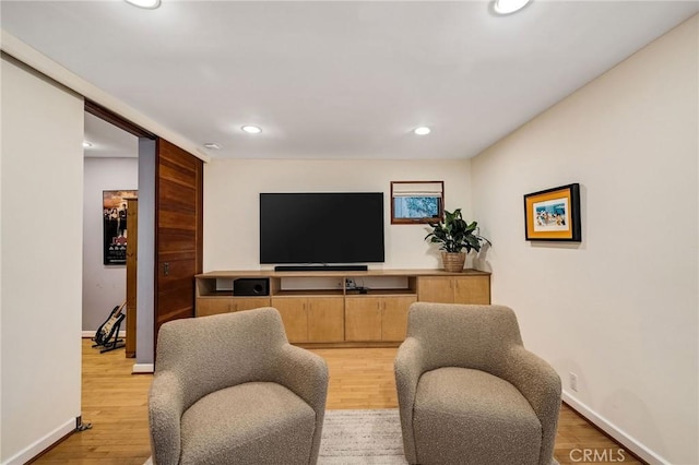 living area featuring recessed lighting, light wood-style flooring, and baseboards