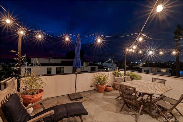 patio at night featuring outdoor dining space