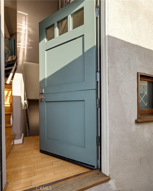 doorway to outside featuring stairs and wood finished floors