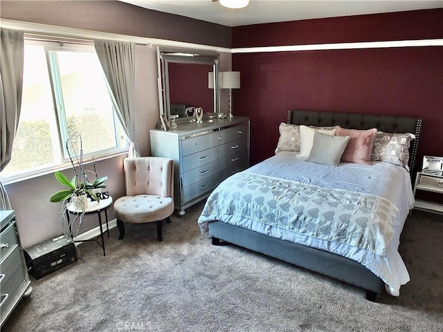 bedroom featuring carpet and baseboards