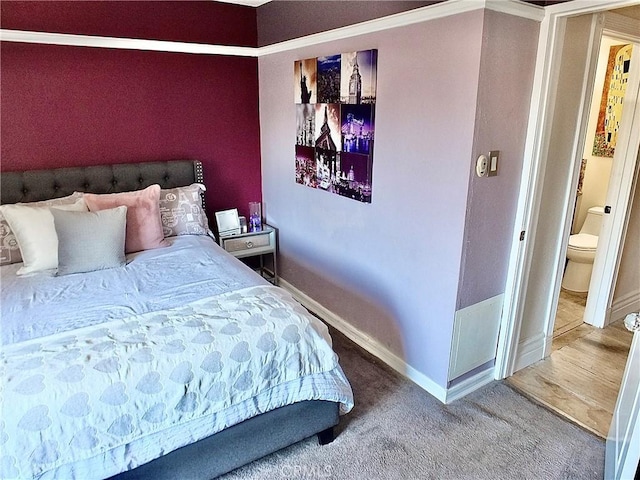 bedroom with carpet floors and baseboards