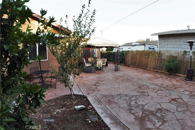 view of patio featuring fence