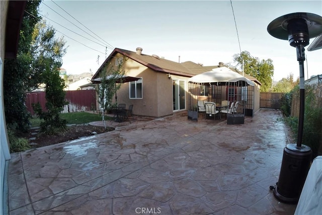 back of property featuring a patio area, a fenced backyard, and stucco siding